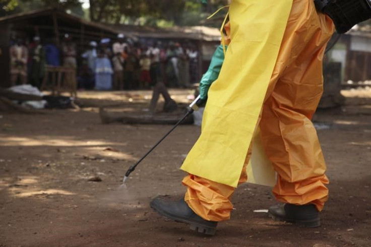 A healthcare workers disinfects the surrounding area. 