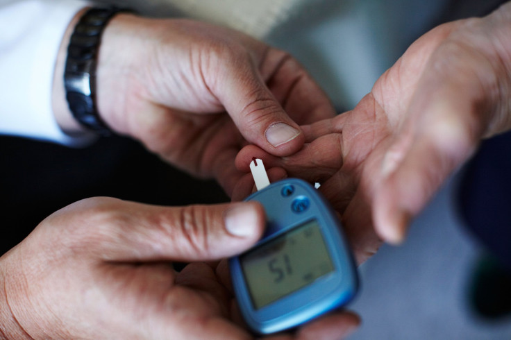 A doctor measures the blood sugar level of a patient. 