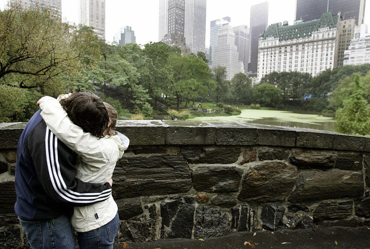 A couple kiss on the Gapstow Bridge in Central Park. 