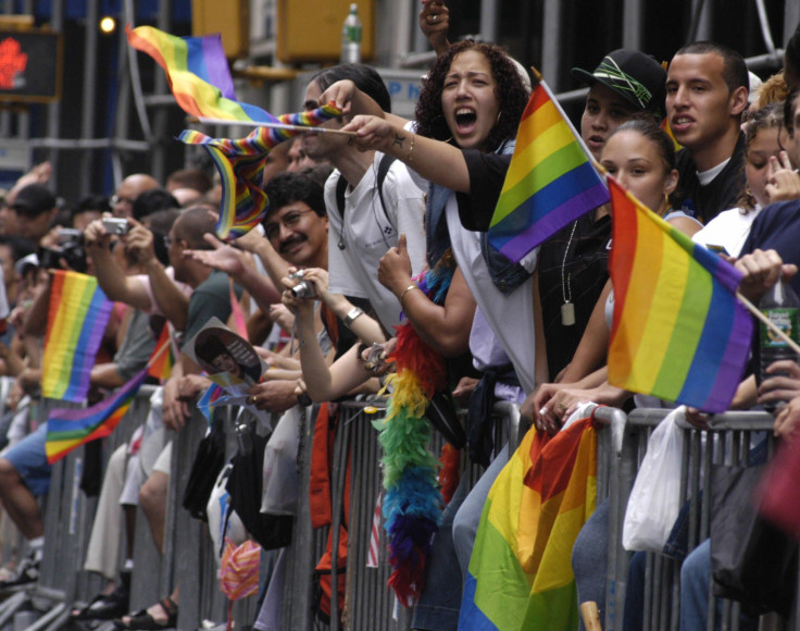 Parade goers wave flags during the LGBT Pride March in NYC. 