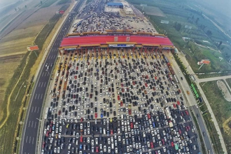 Vehicles are seen stuck in a traffic jam near a toll station as people return home at the end of a week-long national day holiday, in Beijing, China, October 6, 2015.