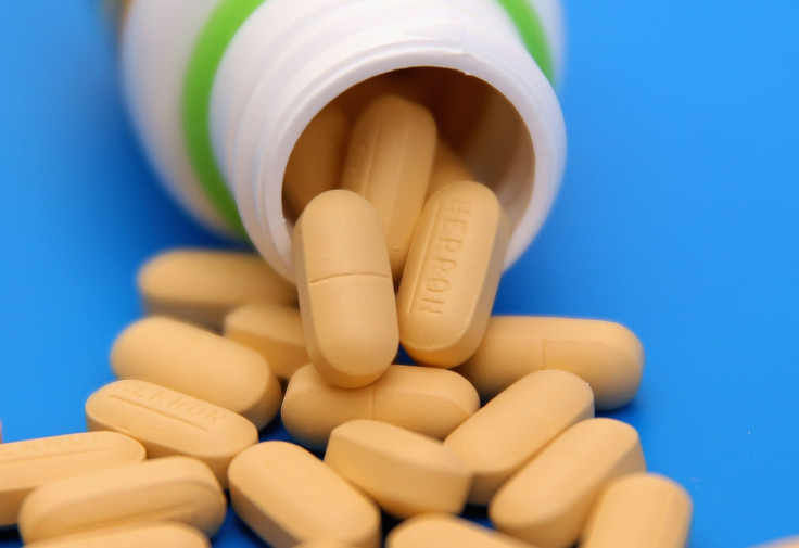 Pain reliever tablets sit on a table. 