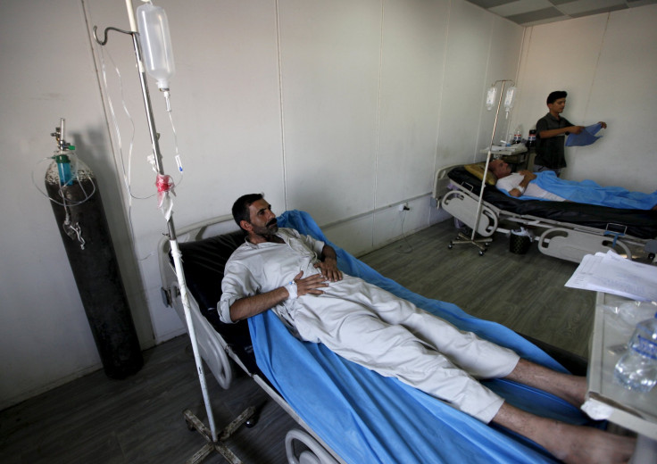 A man lays in a hospital bed. 