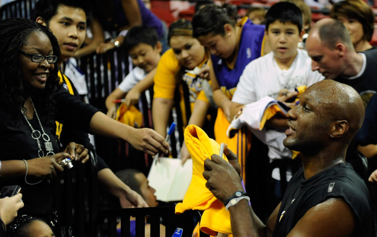 Lamar Odom signs autographs for fans. 