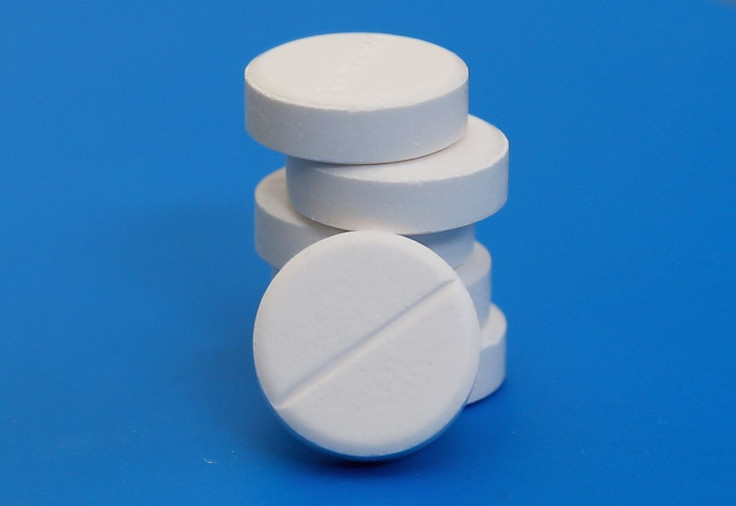 Paracetamol tablets sit on a table. 