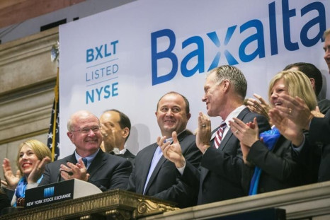 Ludwig Hantson (C), Chief Executive Officer of Baxalta, celebrates the company's IPO after ringing the opening bell above the floor of the New York Stock Exchange, July 1, 2015.