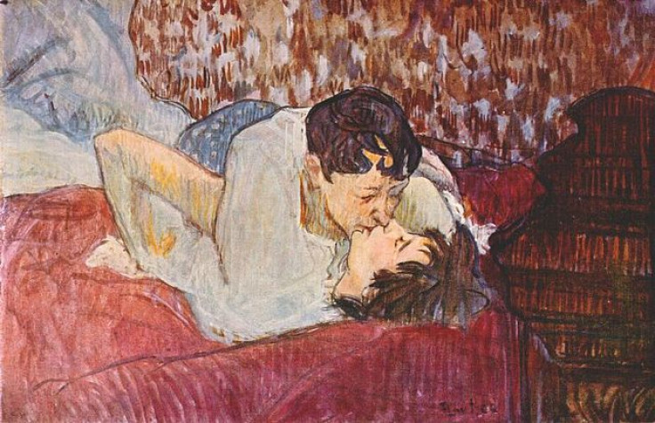 Couple kissing in bed