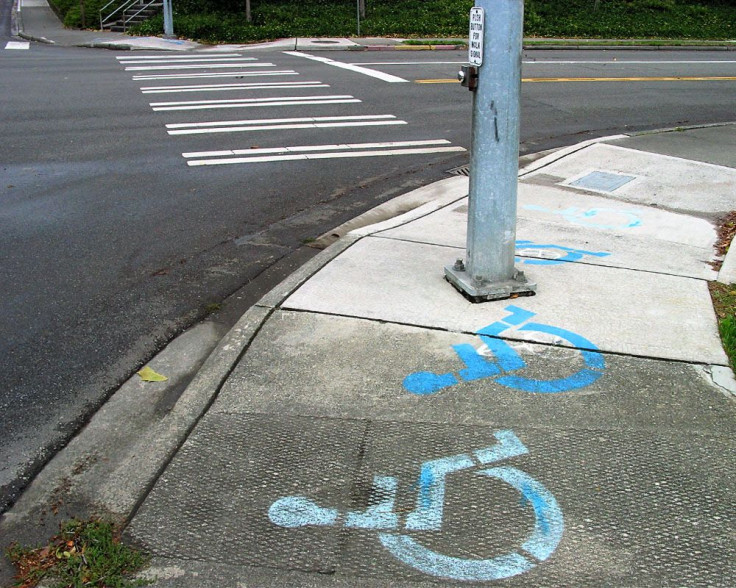 Handicapped sign on sidewalk