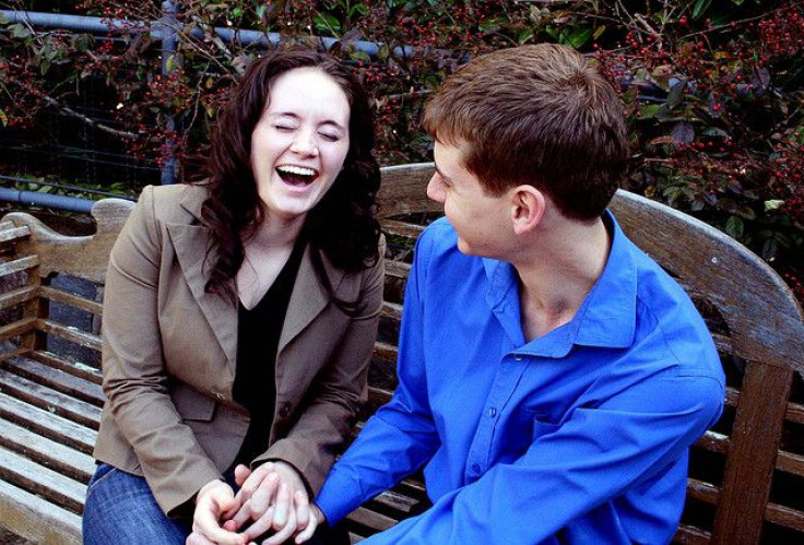 Couple laughing on bench