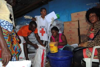 Red Cross workers distribute food at a World Food Programme storage center in Monrovia October 16, 2014.