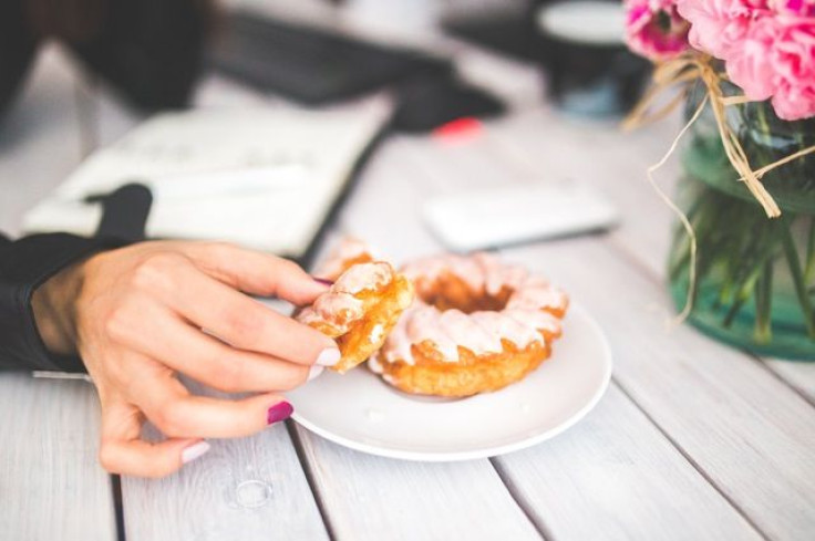 Woman with doughnut in hand