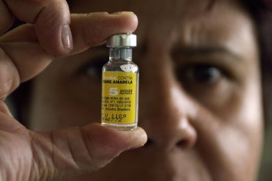 A nurse holds a vial of yellow fever vaccine in Brasilia.