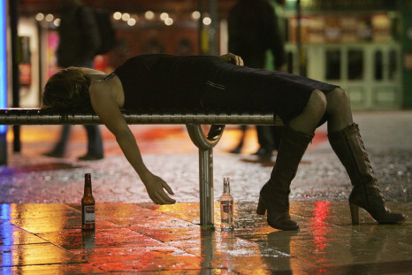 A woman lies on a bench after leaving a bar in Bristol City Centre on October 15, 2005 in Bristol, England.