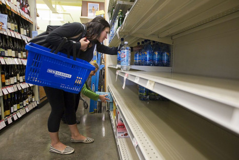 A shopper looks for bottled water on nearly empty shelves at a New Seasons Supermarket May 23, 2014 in Portland, Oregon.