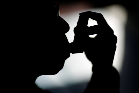 A man uses an inhaler at his house in Beijing, China November 2, 2014.