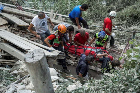 A wounded person is carried out from a collapsed building following an earthquake in Pescara del Tronto, central Italy, August 24, 2016.