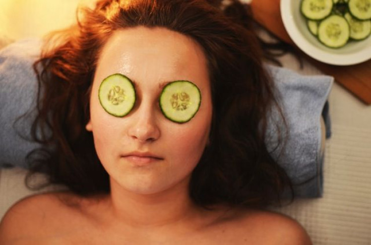 Woman with cucumbers on eyes