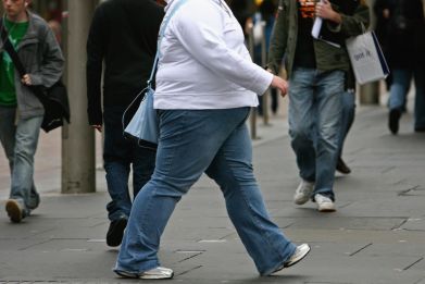 An overweight person walks through Glasgow city centre in Glasgow, Scotland, Oct. 10, 2006.
