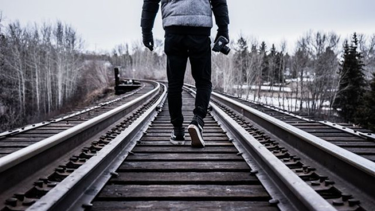 Man walking on train tracks