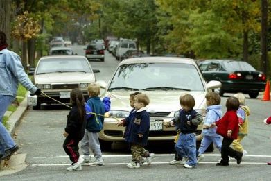 Children are photographed crossing the street.