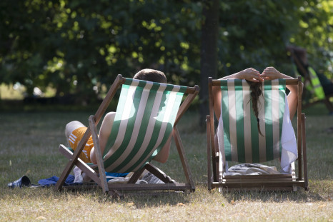 A couple relax on deckchairs in the warm weather in Hyde Park in London, July 18, 2014.