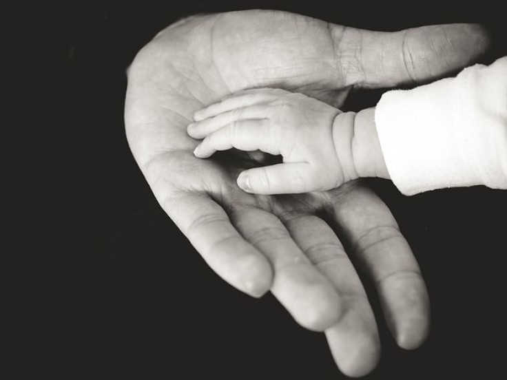 Child's hand on parent