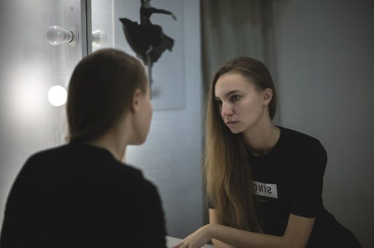 Girl looking in mirror