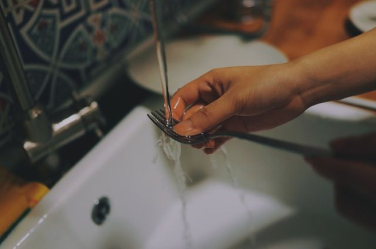 Washing fork in sink