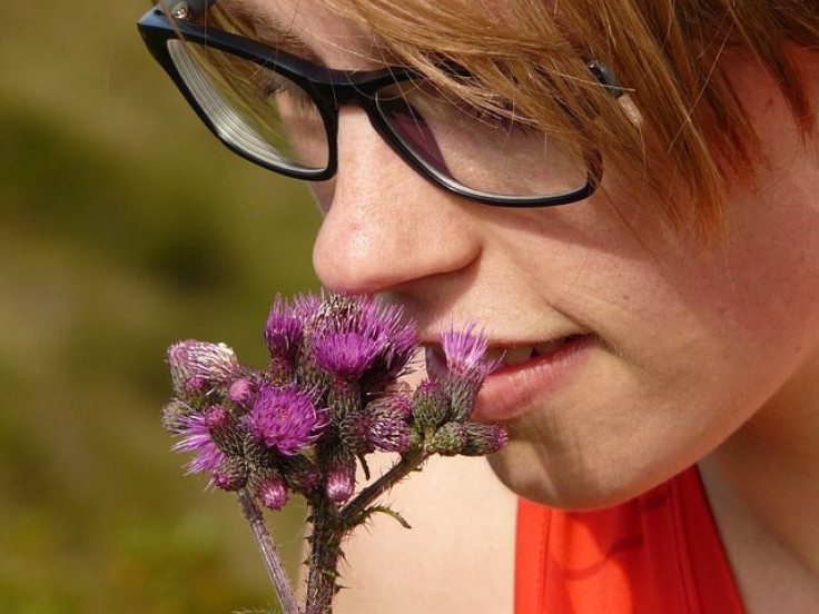 Woman smelling flower