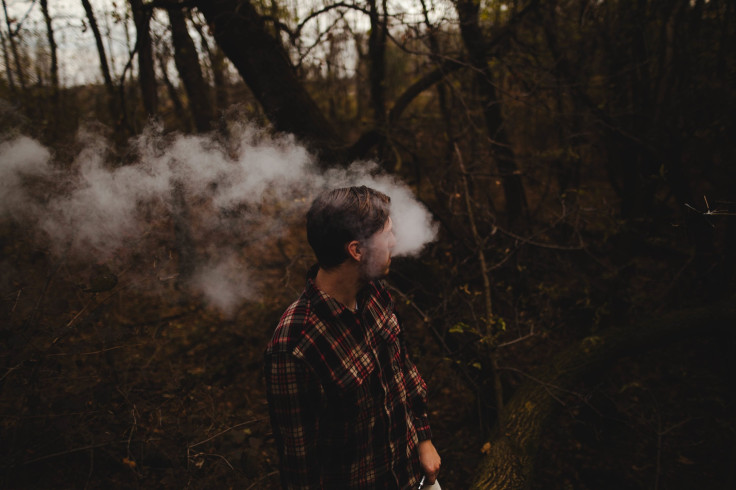 Man smoking in woods