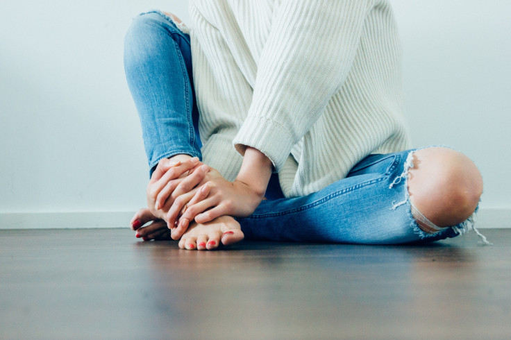 Woman touching hands and feet