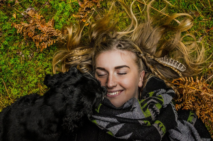 Girl lying on grass with dog