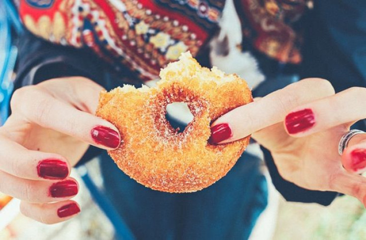 Woman eating doughnut