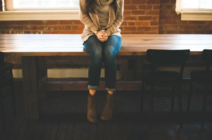 Woman sitting on table