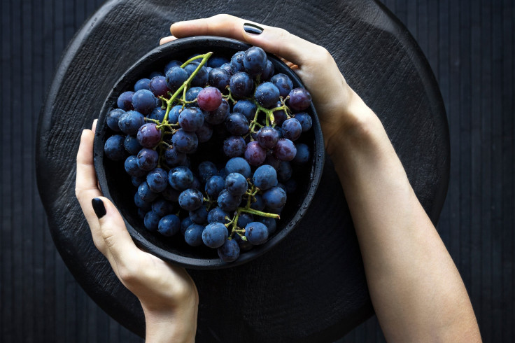 Woman holding bowl of grapes