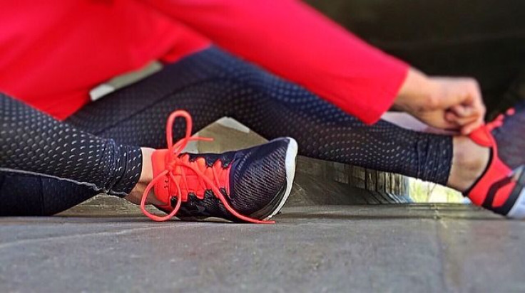 Woman tying sneakers