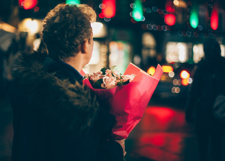 Man holding pink roses