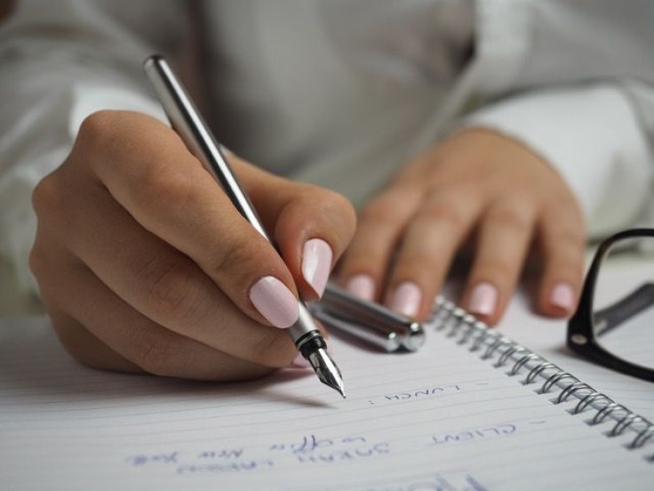 Woman writing in notebook