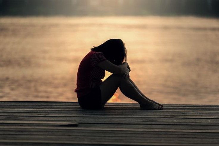 Woman sad near water