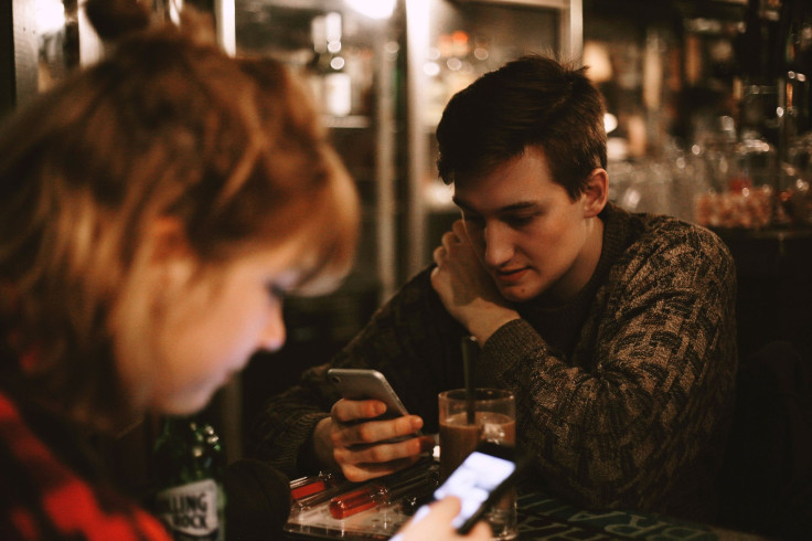 Man and woman using the phone