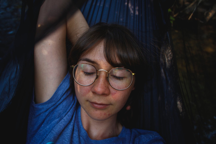 Woman sleeping on hammock