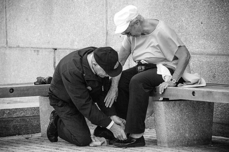 Man tying woman's shoe