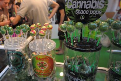 People chat at a cannabis lollipop stand during the Cannabis and Hemp fair, on September 12, 2014 in Irun. In Canada, a 70-year-old-man recently suffered from heart attack after eating most of a cannibal lollipop.