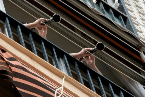 Spanish people play music from their balconies after strict lockdown measures were initiated in the spring  due to the coronavirus.