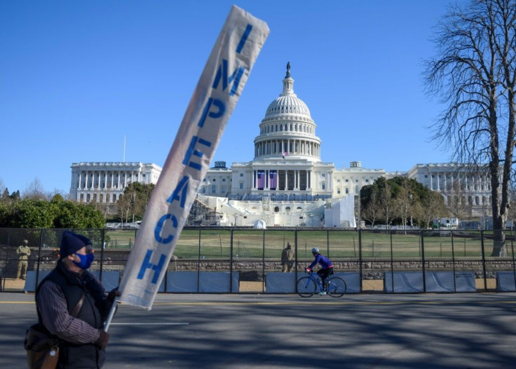 a-protester-carries-a-sign-calling-for-congress