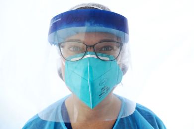 Student nurse Oxana Whitham stands for a portrait in her PPE (personal protective equipment) during COVID-19 testing at a St. John’s Well Child & Family Center mobile clinic set up outside Walker Temple AME Church amid the coronavirus pandemic on July 15, 2020 in Los Angeles, California.