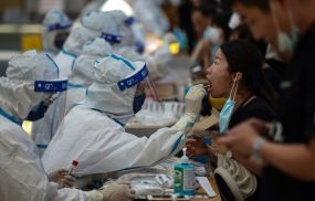 A medical worker performs a Covid test in Jiangsu province, China.