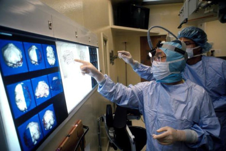 Pictured: Surgeons at Johns Hopkins examine scans from Chris Cotter's brain in 1995 in Baltimore, Maryland. Cotter suffered from epilepsy and surgeons implanted a diagnostic grid of electrodes in his brain to determine what portion was causing the seizures by analyzing information from the grid during the episodes.