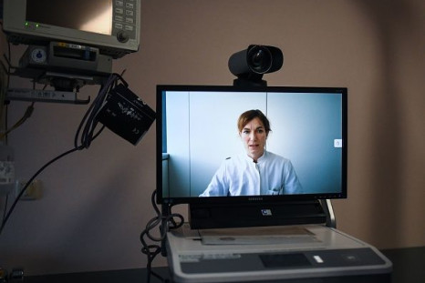 A monitor shows intensive care physician Judith Ibba at the University hospital in Aachen as she speaks during an online meeting about a COVID-19 case while using telemedicine on January 26, 2021 at the Bethlehem Hospital in Stolberg, western Germany, amid the ongoing coronavirus pandemic.