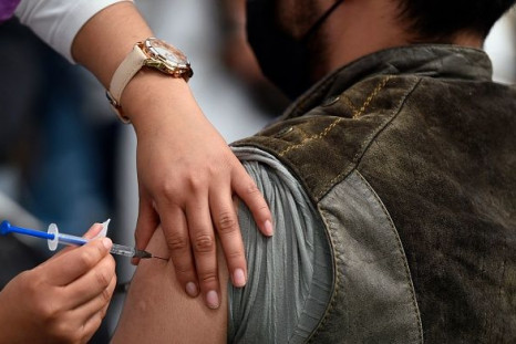 A nurse inoculates a man with a booster dose of the AstraZeneca vaccine against COVID-19 in Mexico City, on February 15, 2022.